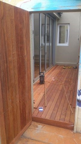 The Squeaky Floors team assessing a timber floor
